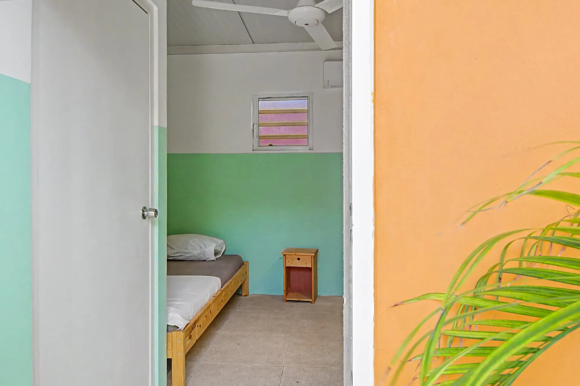 Casa 7 bedroom entrance with ceiling fan and tropical decor