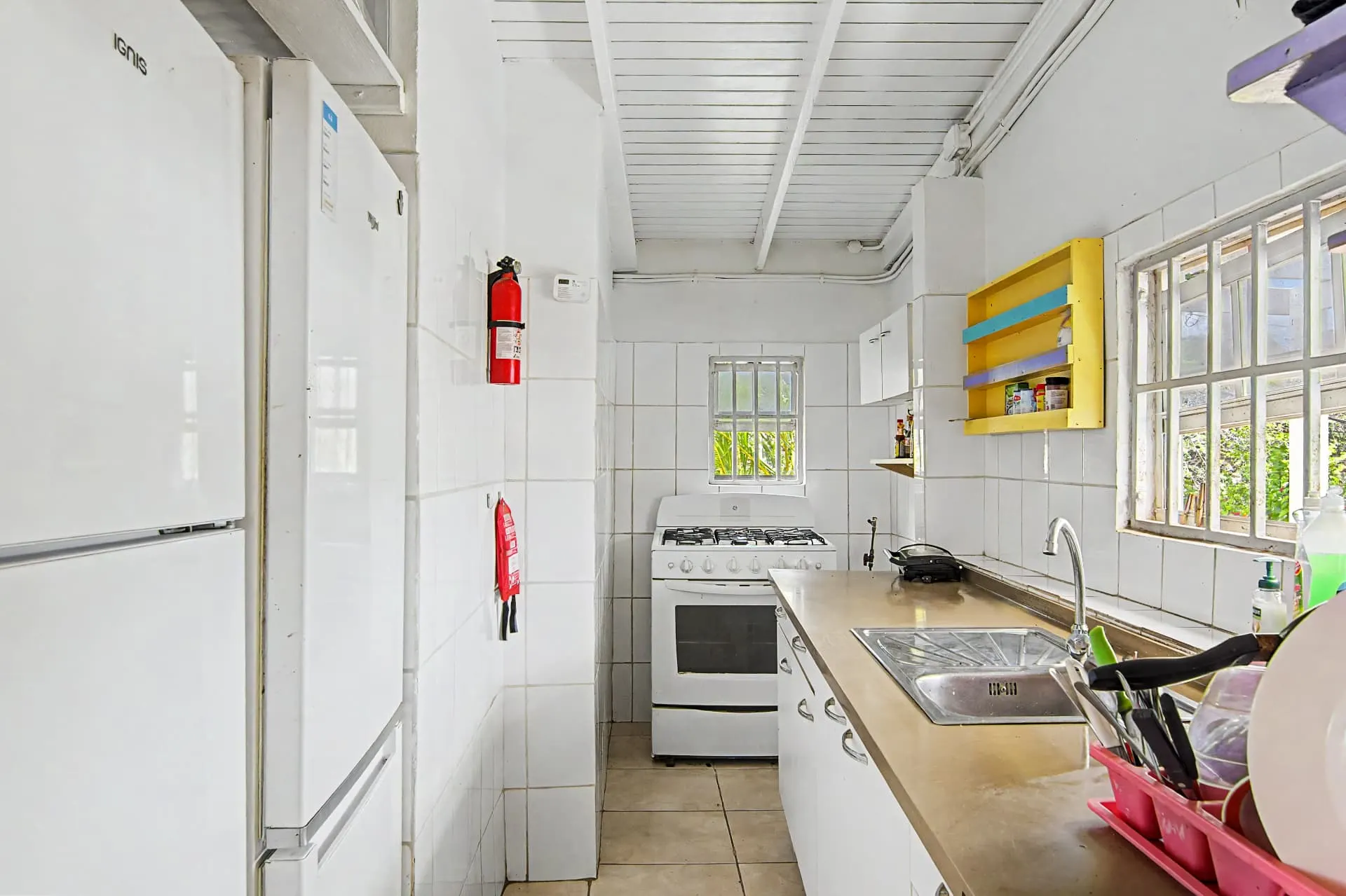 Casa 2 shared kitchen with stove, fridge, and sink
