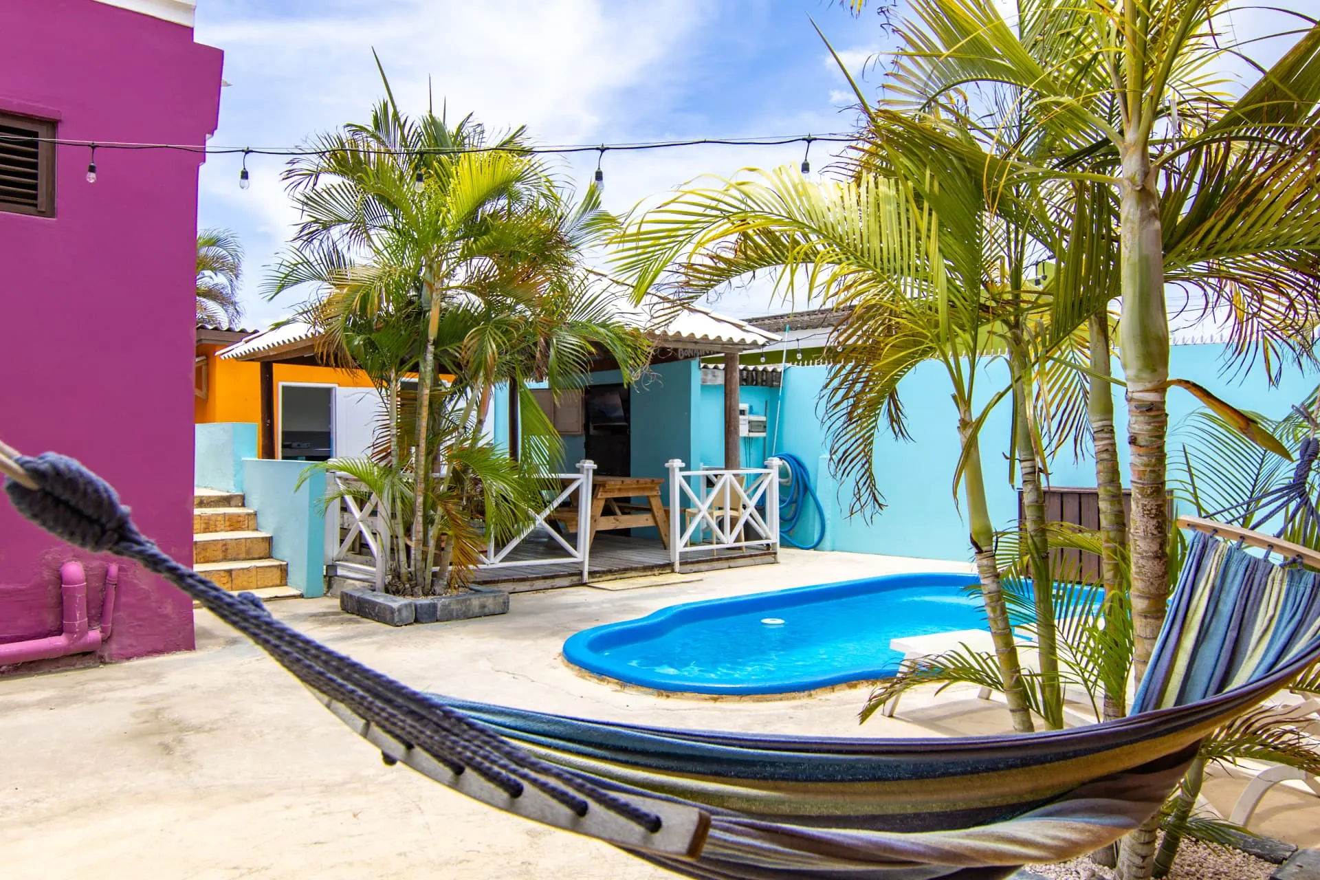 Casa 7 pool area with hammock and palm trees