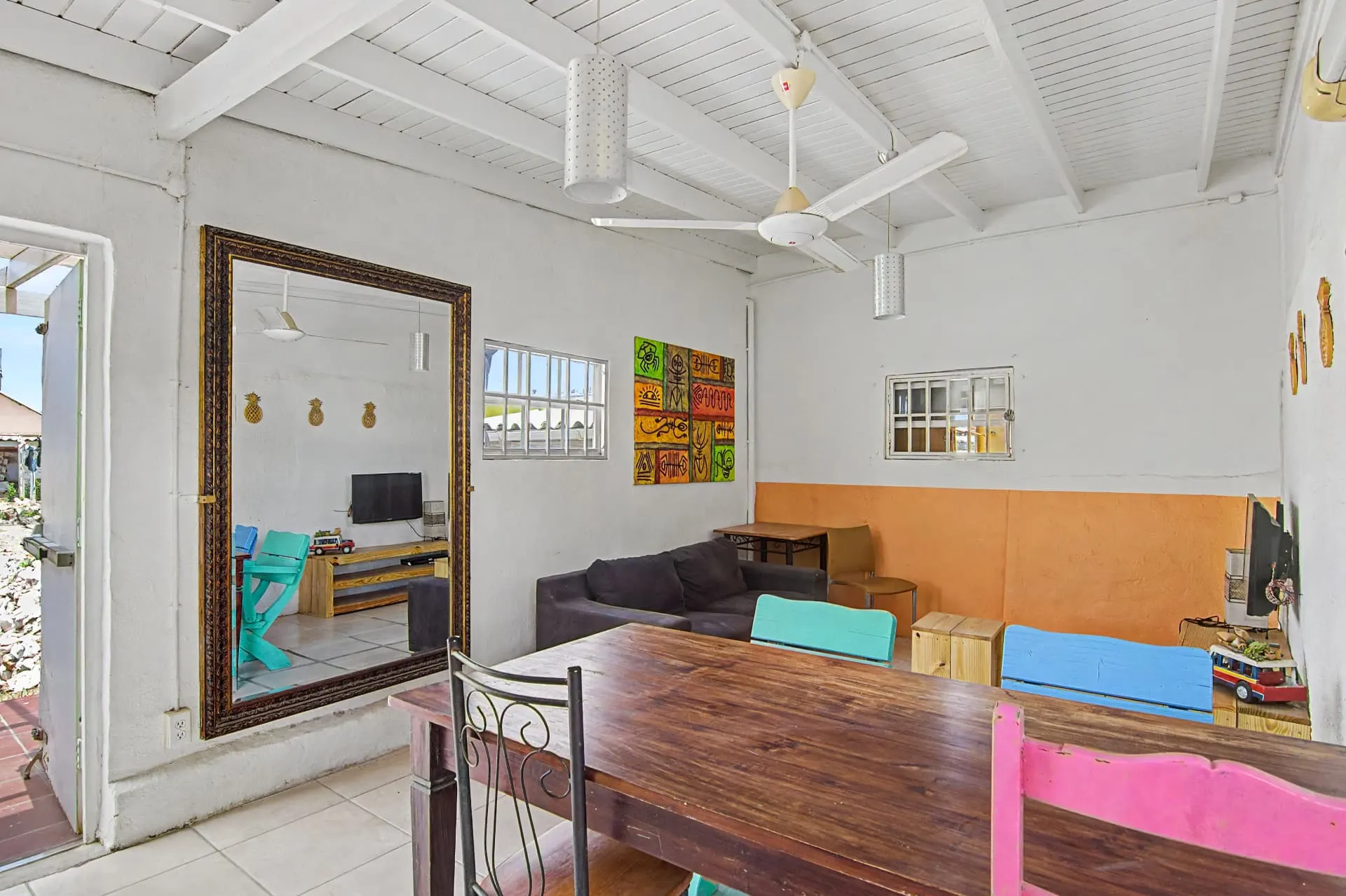 Casa 2 bright indoor lounge with colorful chairs